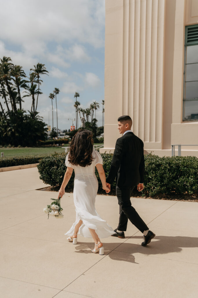 a male and female walking away who just got eloped at the San Diego Courthouse. 